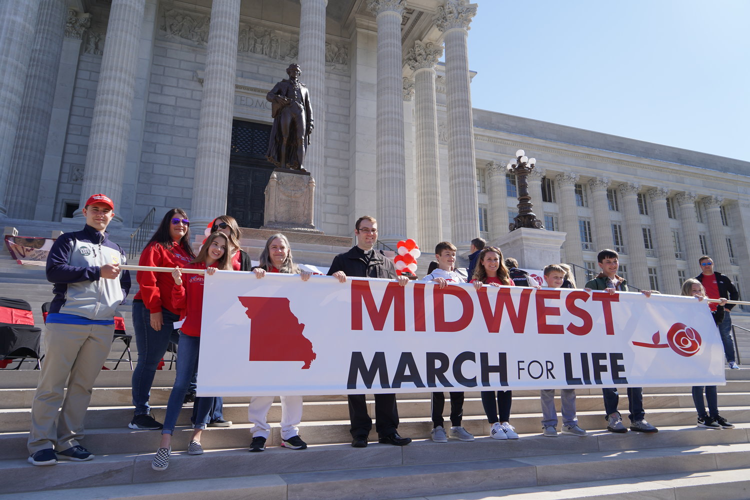 Members of St. Brendan Parish in Mexico, including their pastor, Father Dylan Schrader, carry the Midwest March for Life banner.